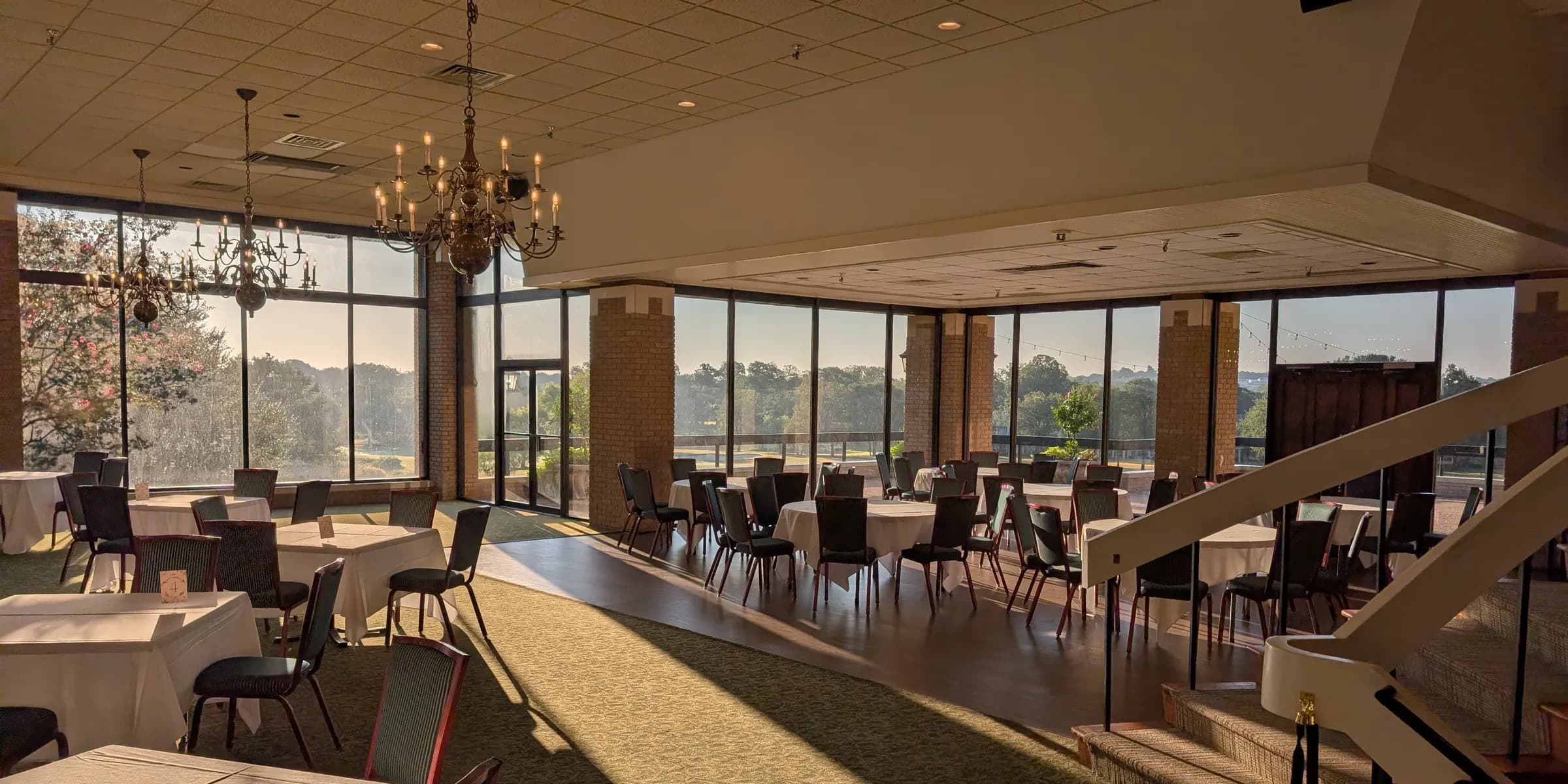 The ballroom at Onion Creek Club in early morning light, tables set and empty before check-in