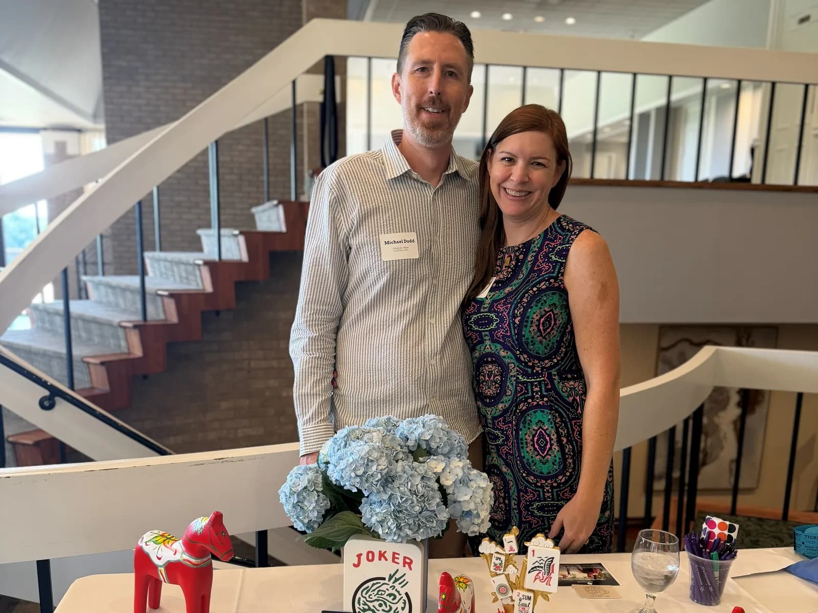 Michael and Sara Dodd behind the Mahj for More welcome table